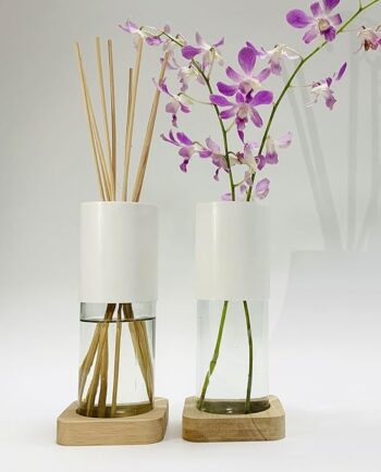 reed / scent diffuser vase with fresh orchid flower scenario